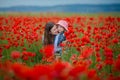 Beautiful young woman with child girl in poppy field. happy family having fun in nature. outdoor portrait in poppies. mother with Royalty Free Stock Photo