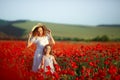 Beautiful young woman with child girl in poppy field. happy family having fun in nature. outdoor portrait in poppies Royalty Free Stock Photo