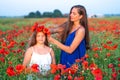 elegant young woman with child girl in poppy field, happy family having fun in nature, summer time Royalty Free Stock Photo