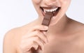 Beautiful young woman with chocolate on light background, closeup Royalty Free Stock Photo
