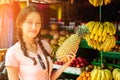 Beautiful and young woman is choosing fruit on the market in asia. concept of tourism and recreation Royalty Free Stock Photo