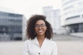 Beautiful young woman in a city. Smiling african american student girl looking at camera. Smiling businesswoman portrait. Royalty Free Stock Photo