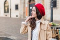 Beautiful young woman at city street. Happy tourist girl walking outdoors. Spring portrait of pretty brunette female posing in old Royalty Free Stock Photo