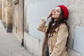 Beautiful young woman at city street. Happy tourist girl walking outdoors. Spring fashion portrait of pretty brunette female Royalty Free Stock Photo