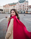 Beautiful young woman at city street. Happy tourist girl walking outdoors. Spring portrait of pretty brunette female posing in old Royalty Free Stock Photo