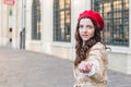 Beautiful young woman at city street. Happy tourist girl walking outdoors. Spring portrait of pretty brunette female posing in old Royalty Free Stock Photo