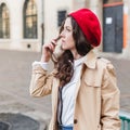 Beautiful young woman at city street. Happy tourist girl walking outdoors. Spring portrait of pretty brunette female posing in old Royalty Free Stock Photo