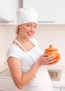 Beautiful young woman with a clay pot