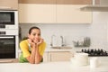 Beautiful young woman with clean dishes and cups at table Royalty Free Stock Photo