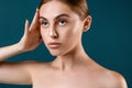 Beautiful young woman with clean perfect skin. Hand pose near head. Portrait of beauty model with natural nude make up and long ey Royalty Free Stock Photo