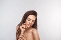 Beautiful young woman with clean perfect skin. Portrait of beauty model with natural nude make up and touching her face. Spa, skin Royalty Free Stock Photo