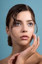 Beautiful young woman with clean perfect skin and water moisture drops touching face Royalty Free Stock Photo