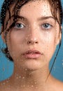 Beautiful young woman with clean perfect skin and water moisture drops touching face Royalty Free Stock Photo