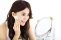 Beautiful young woman cleaning her face with cotton Royalty Free Stock Photo