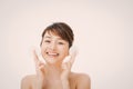 Beautiful young woman cleaning her face with cotton Royalty Free Stock Photo