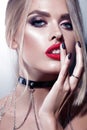 Beautiful young woman close-up portrait with red lips and braces. Blonde stylish hair. Royalty Free Stock Photo