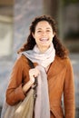 Beautiful young woman in coat and scarf smiling Royalty Free Stock Photo