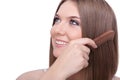 Beautiful young woman combing her hair Royalty Free Stock Photo