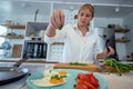 Beautiful young woman cooking in a modern kitchen. Royalty Free Stock Photo