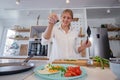 Beautiful young woman cooking in a modern kitchen. Royalty Free Stock Photo