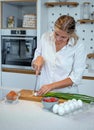 Beautiful young woman cooking in a modern kitchen. Royalty Free Stock Photo