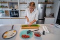 Beautiful young woman cooking in a modern kitchen. Royalty Free Stock Photo