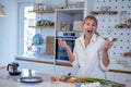 Beautiful young woman cooking in a modern kitchen. Royalty Free Stock Photo