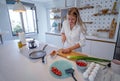 Beautiful young woman cooking in a modern kitchen. Royalty Free Stock Photo