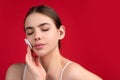 Beautiful young woman with cotton pad removing makeup. Skin care. Studio portrait of girl cleaning her face with cotton Royalty Free Stock Photo