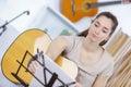 Beautiful young woman on couch with guitar