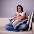 Beautiful young woman, on the couch watching TV, Royalty Free Stock Photo