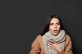 Beautiful young woman coughing against dark background Royalty Free Stock Photo