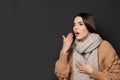 Beautiful woman coughing against dark background Royalty Free Stock Photo