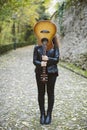 Beautiful young woman covering her face with a guitar. Royalty Free Stock Photo