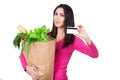 Beautiful young woman with credit card holding paper bag with groceries. Isolated. Shopping and groceries concept. Royalty Free Stock Photo