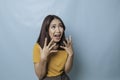 Beautiful young woman crying feeling very depressed  by blue background shouting loud Royalty Free Stock Photo