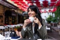 Beautiful young woman with cup of coffee. Woman enjoys fresh coffee in the morning with sunrise at coffe shop Beautiful woman Royalty Free Stock Photo