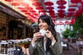 Beautiful young woman with cup of coffee. Woman enjoys fresh coffee in the morning with sunrise at coffe shop Beautiful woman Royalty Free Stock Photo