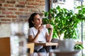 Beautiful young woman with cup of coffee. Woman enjoys fresh coffee in the morning with sunrise at coffe shop beautiful woman Royalty Free Stock Photo