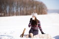 Beautiful young woman with cup of coffee in winter nature Royalty Free Stock Photo