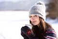 Beautiful young woman with cup of coffee in winter nature Royalty Free Stock Photo