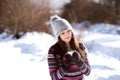 Beautiful young woman with cup of coffee in winter nature Royalty Free Stock Photo