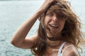 Beautiful young girl with brown hair and awesome eyes on the ocean beach in the metropolis Hong Kong Royalty Free Stock Photo