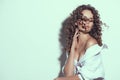 Beautiful young woman with curly hair posing, beauty model portrait, closeup. Beautiful sexy model girl in white cotton shirt Royalty Free Stock Photo