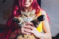 Beautiful young woman with cute cat resting at home. Royalty Free Stock Photo