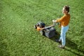 Woman cutting grass with lawn mower Royalty Free Stock Photo