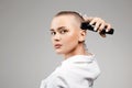 Beautiful young woman cutting her hair. bald Girl with hairclipper Royalty Free Stock Photo