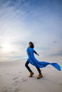 Beautiful young woman dancing in the desert on the wind Royalty Free Stock Photo