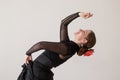 Beautiful young woman dancing flamenco in a black dress. In the dance, she bent back beautifully Royalty Free Stock Photo