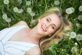 Beautiful young woman among dandelions Royalty Free Stock Photo